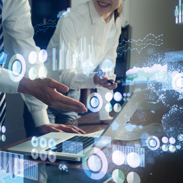 Two professional AI technology consultants collaborating over a laptop, with a futuristic digital overlay showing data visualization charts, global networks, and intelligent workflow analytics.